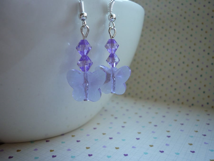 LILAC AND SILVER FACETED GLASS BUTTERFLY EARRINGS.