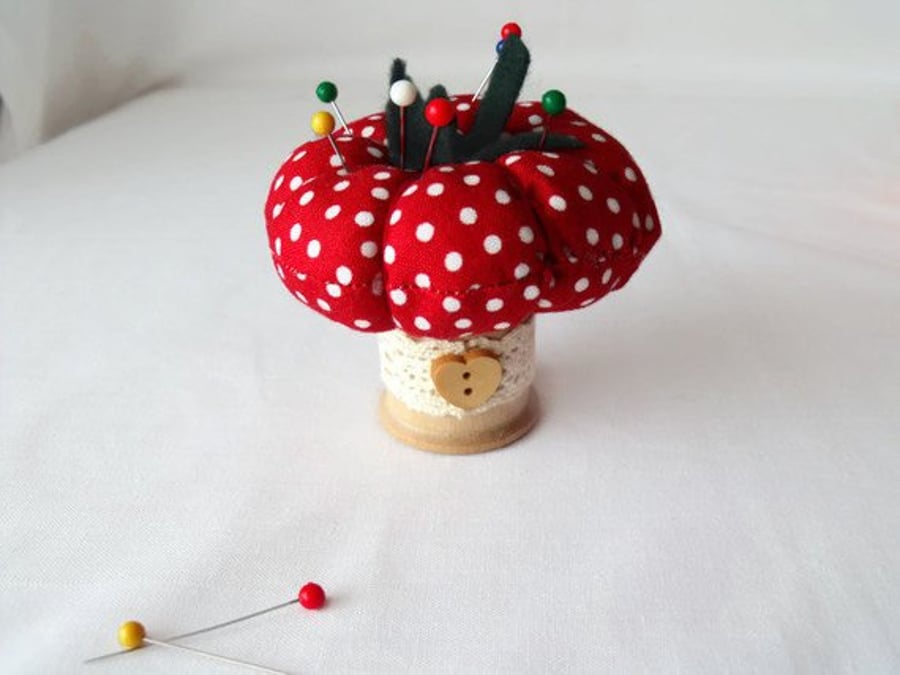 novelty tomato pin cushion on a vintage wooden bobbin