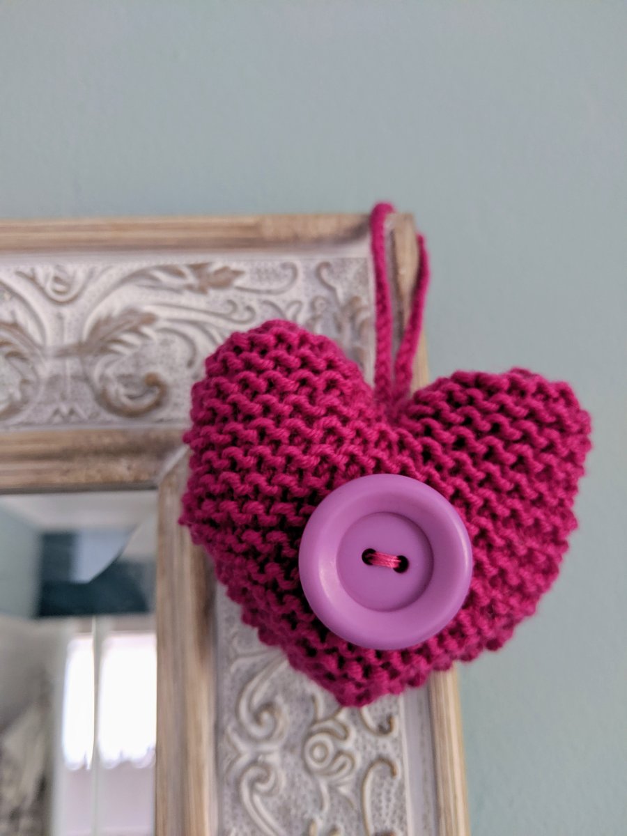 Hand-knitted magenta button heart