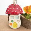 Ceramic toadstool decoration with yellow door