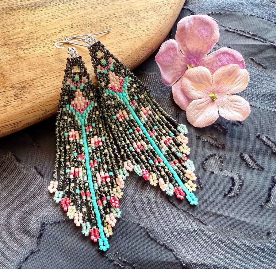 Handwoven beaded fringe earrings in a black floral pattern
