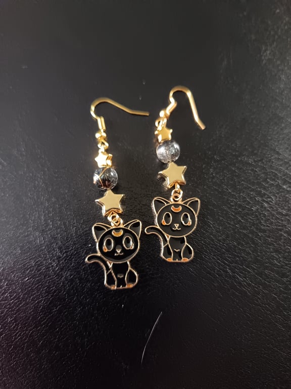 Black and gold cat charm dangle earrings with beads and stars