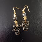 Black and gold cat charm dangle earrings with beads and stars