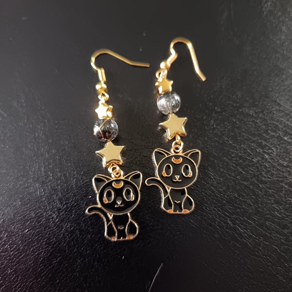 Black and gold cat charm dangle earrings with beads and stars