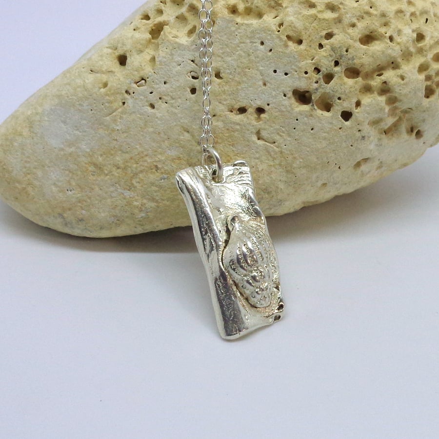 Silver sea shell set on driftwood pendant