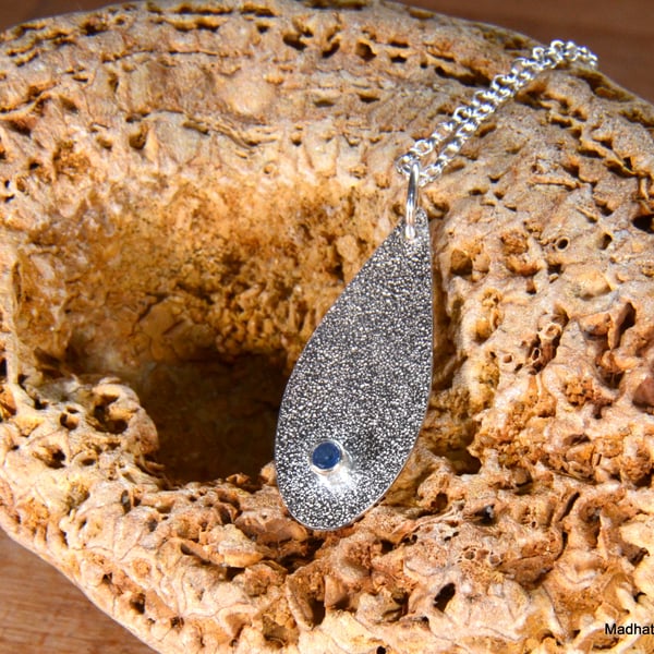 Textured silver teardrop pendant with topaz stone