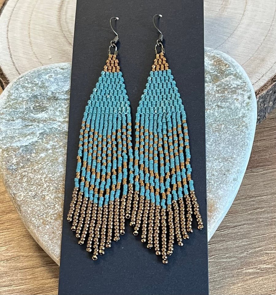 Long Native American style beaded fringe earrings in blue and bronze