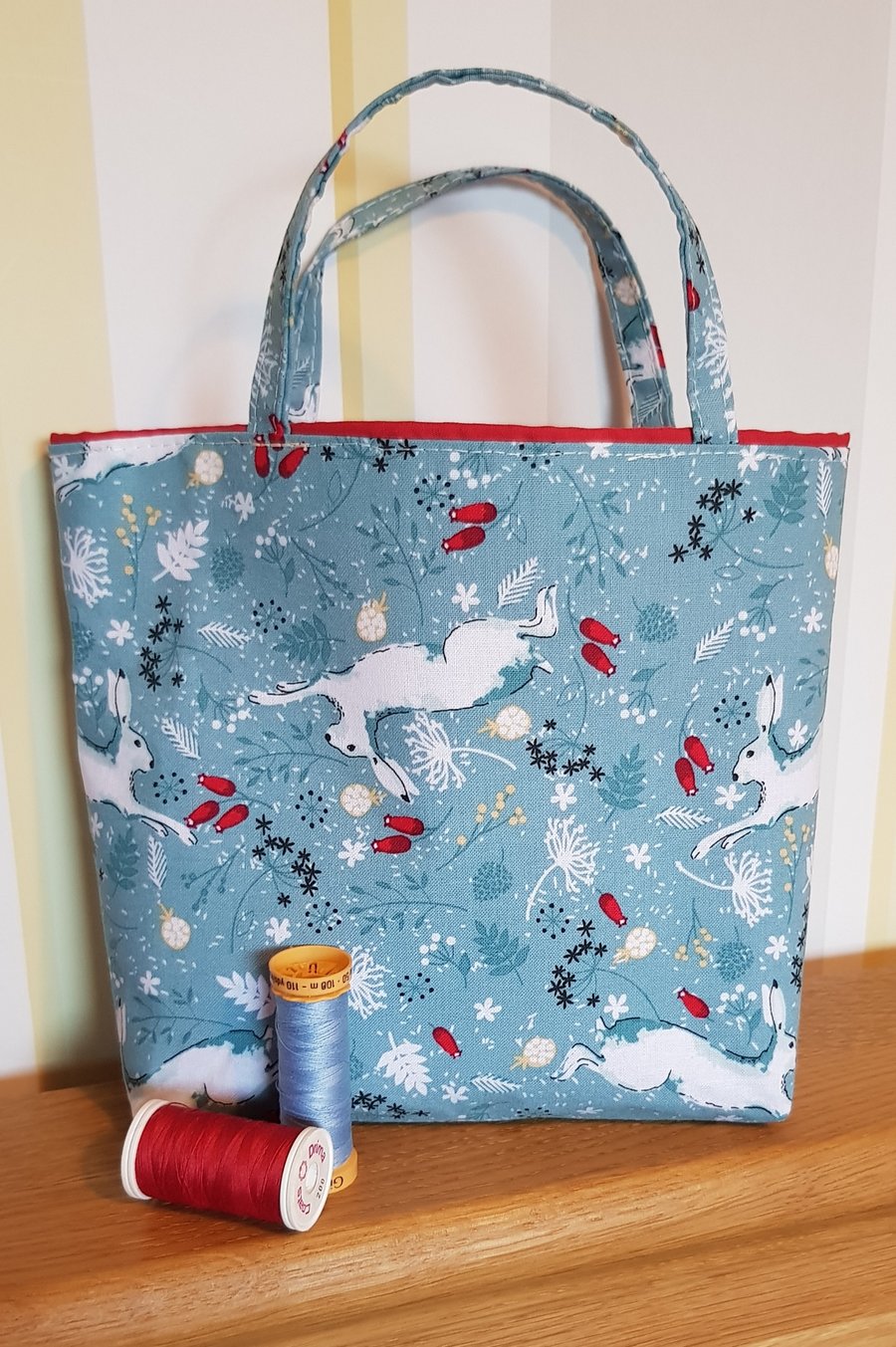 Christmas gift bag: dancing hares on blue 