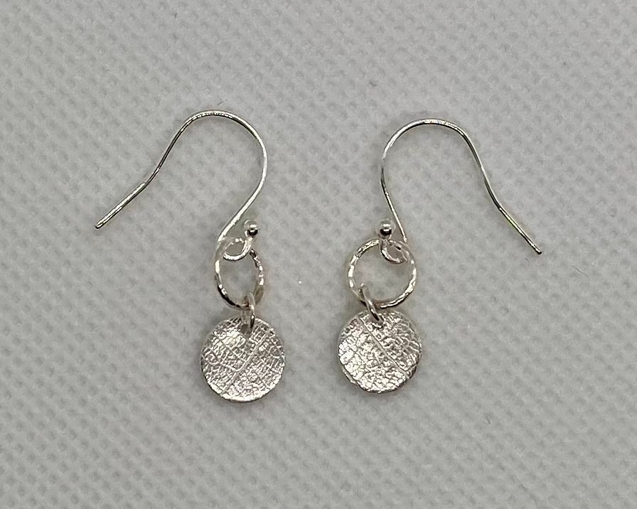 Pure silver earrings with an embossed leaf texture. 