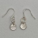 Pure silver earrings with an embossed leaf texture. 