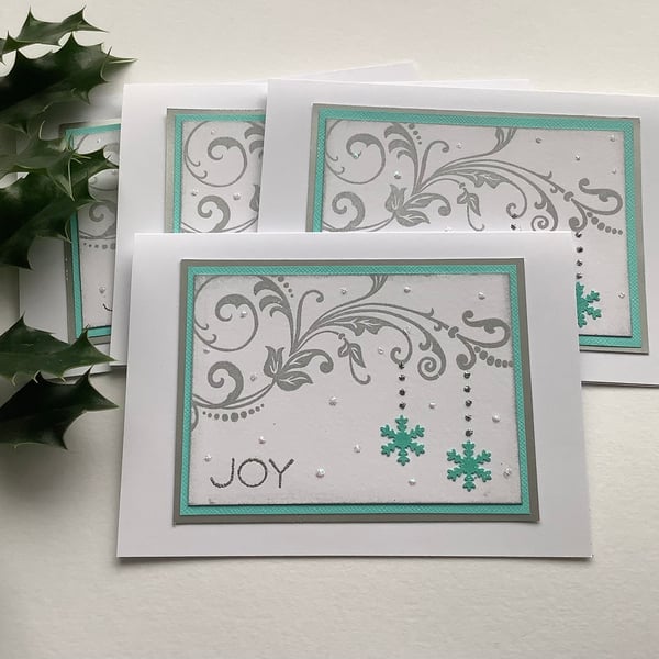  CHRISTMAS CARDS, pack of 4, ' Joy’. Aqua blue, silver . Flourish. Snowflake.