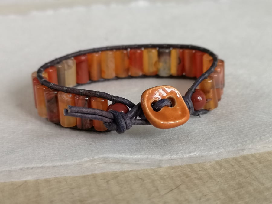 Orange agate semi precious bead and navy leather bracelet with ceramic button 