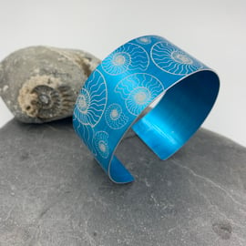 Turquoise anodised aluminium ‘ammonite’ cuff