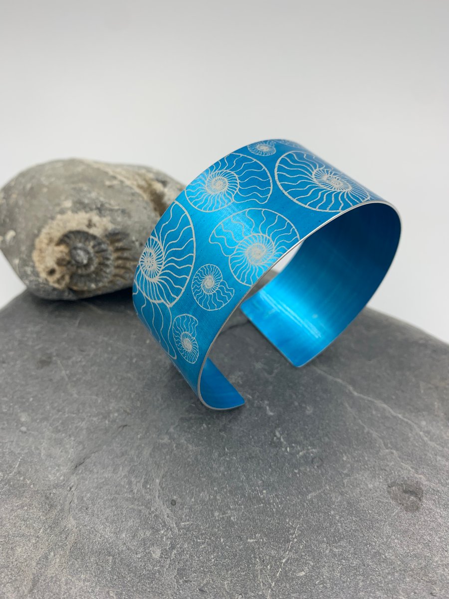 Turquoise anodised aluminium ‘ammonite’ cuff
