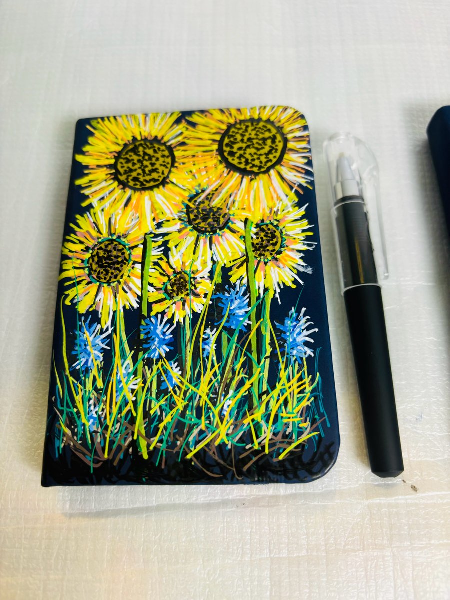 A hand painted and sealed faux leather notebook by Andrew Jenkins 