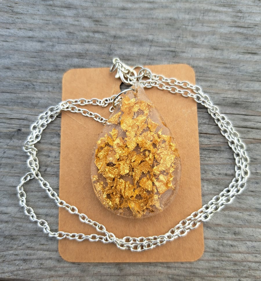 Gold leaf oval resin pendant on a silver plated link chain 