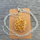 Gold leaf oval resin pendant on a silver plated link chain 