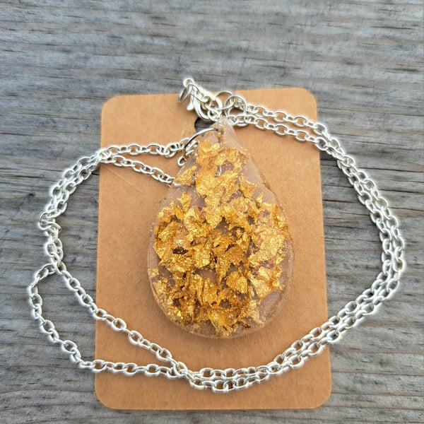 Gold leaf oval resin pendant on a silver plated link chain 