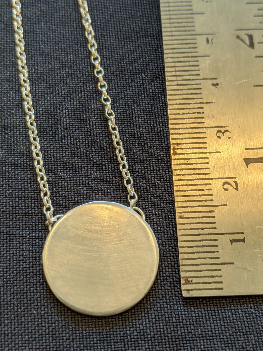 Elegant contemporary silver disc pendant on a belcher chain