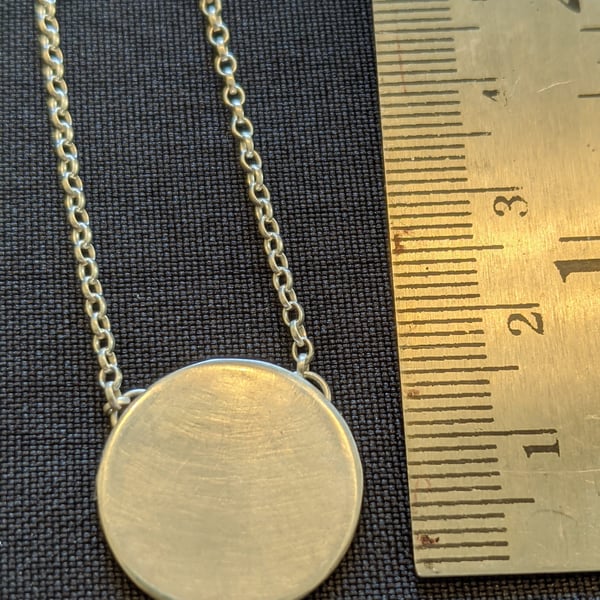 Elegant contemporary silver disc pendant on a belcher chain