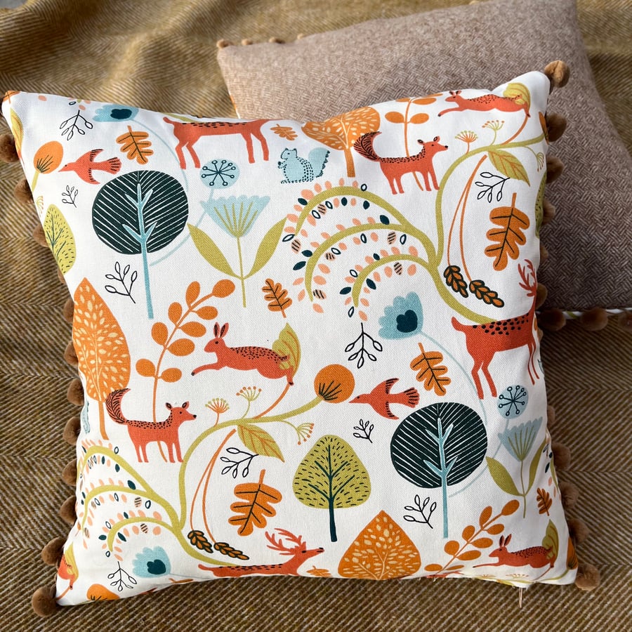 Forest animals cushion cover with herringbone wool tweed back and pompoms