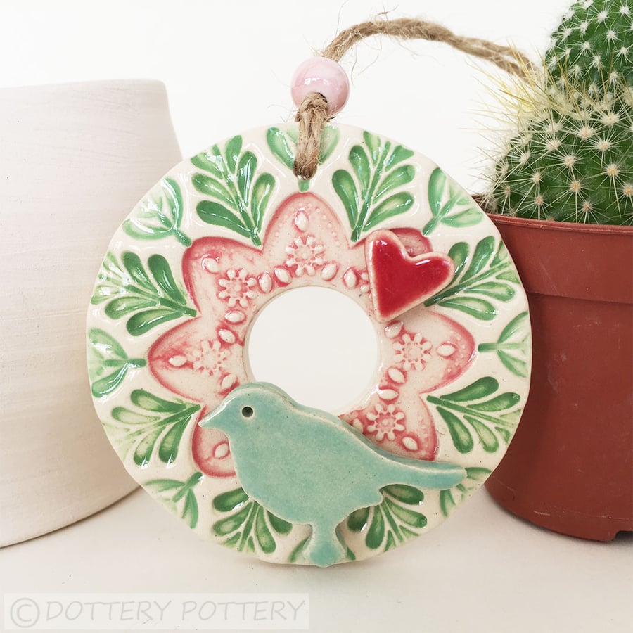 Small ceramic floral wreath decoration with bird and heart pottery bird