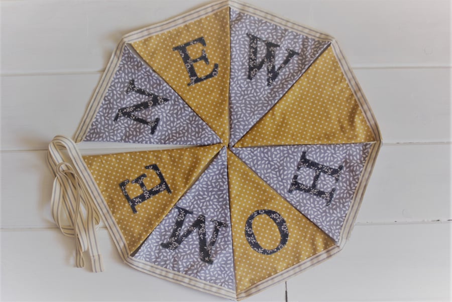 New Home bunting in mustard and grey with hand-stitched personalisation