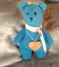 Teddy bear from repurposed teal woolly jumper with flowery neckerchief