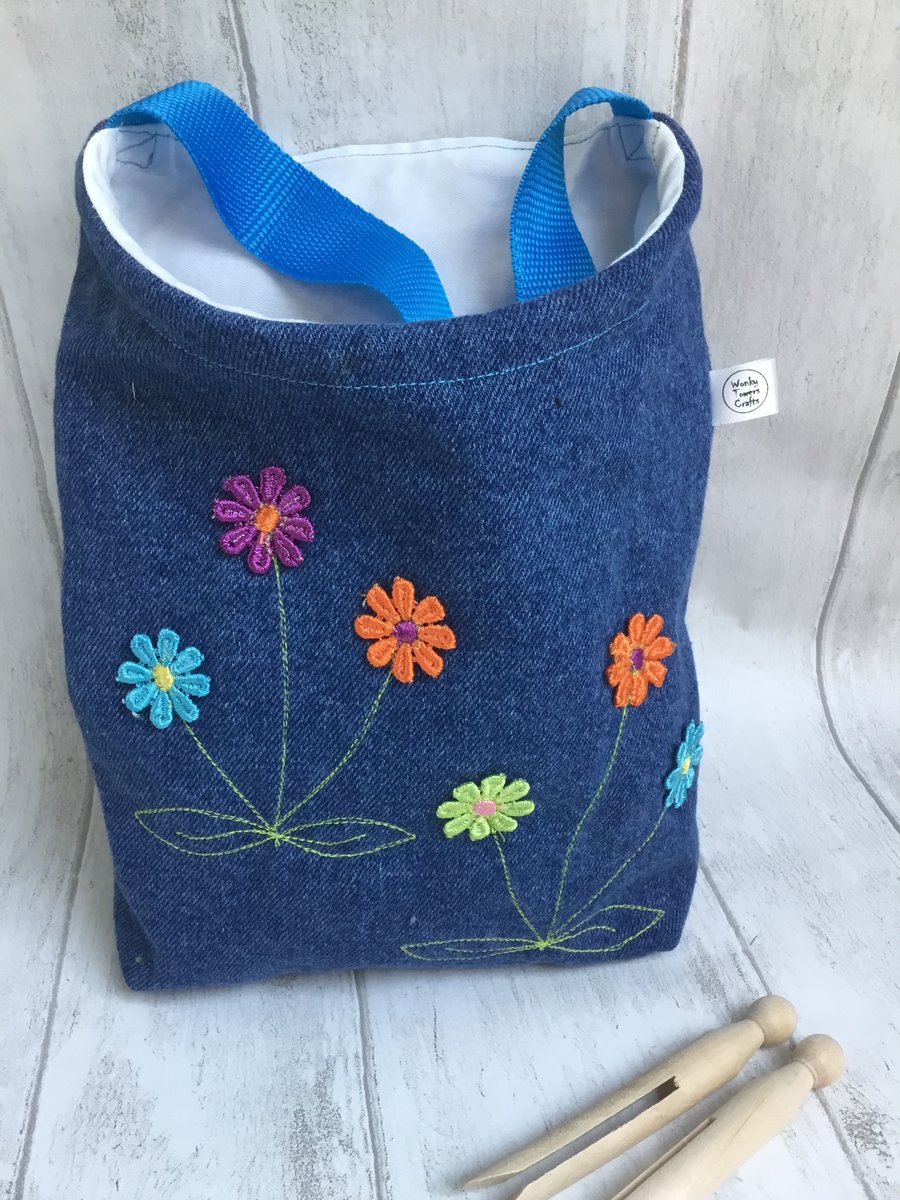 Peg bag with shoulder strap. Recycled denim with flower decoration