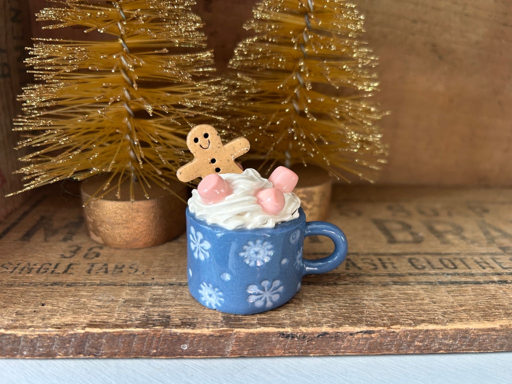 Gingerbread man in a mug standing decoration blue mug slight second.