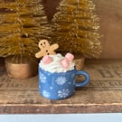 Gingerbread man in a mug standing decoration blue mug slight second.