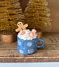 Gingerbread man in a mug standing decoration blue mug slight second.