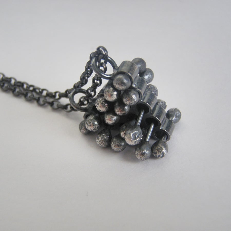 Silver triangle necklace pendant fidget sensory jewellery.