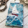 Up cycled seascape keyring with sail boat. 