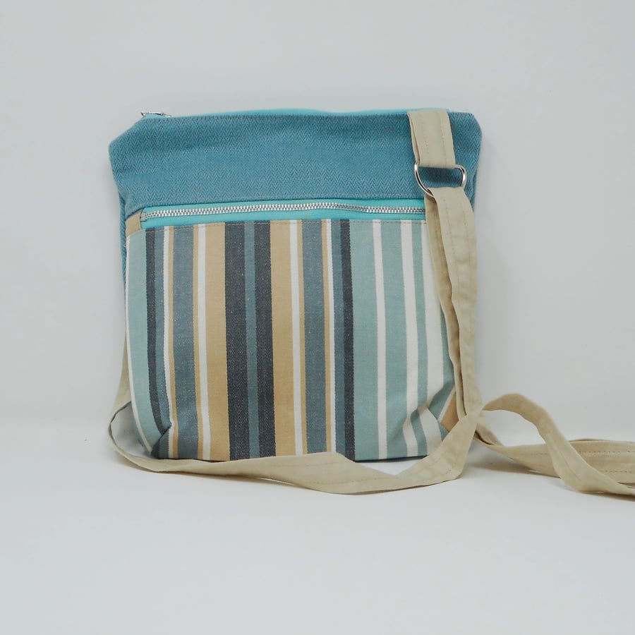 Striped fabric crossbody bag with zipped pocket on front