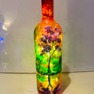 A hand painted and fired glass bottle vase by Andrew Jenkins 