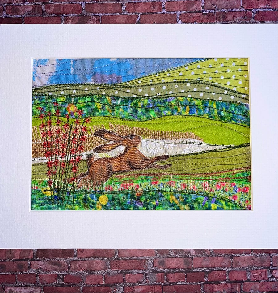 Textile unframed picture with hare in landscape 