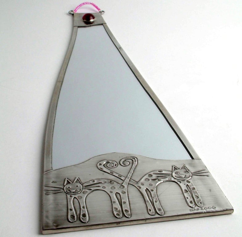 Bathroom mirror with cat design.