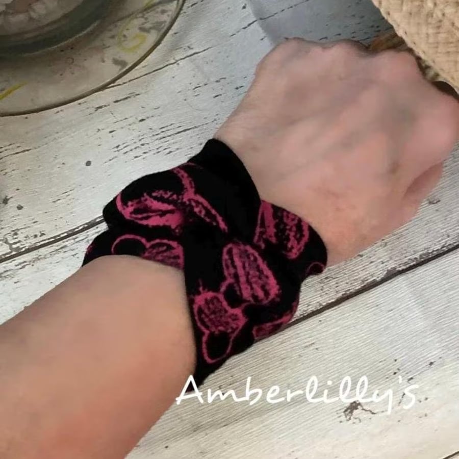 Wide wrist covering bracelet in pink and black