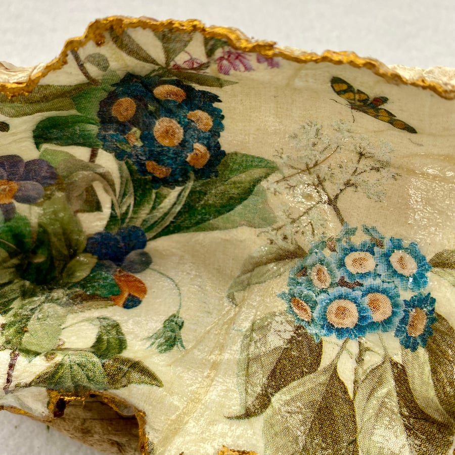 Handmade decoupaged oyster shell featuring primulas