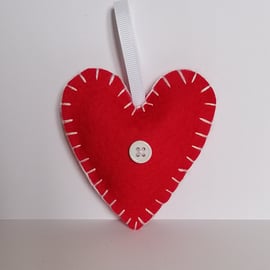 Handmade red felt heart with white stitching, ribbon and button 