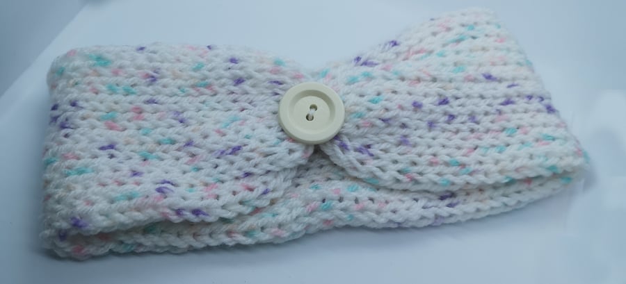 Handknitted white earwarmer with flecks of pink, purple and blue