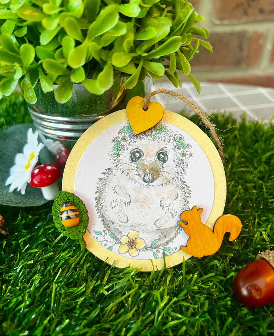 ‘Wooden hanging decoration’ - Artists Illustration of a hedgehog with squirrel