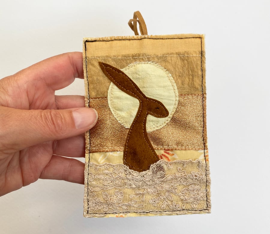 Upcycled embroidered harvest hare home decoration. 