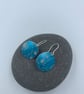 Turquoise anodised aluminium ammonite circle earrings - Image 1