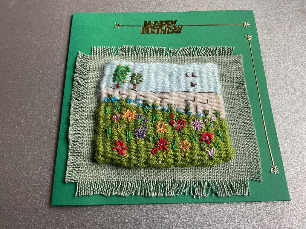 Attractive woven card representing a field of flowers