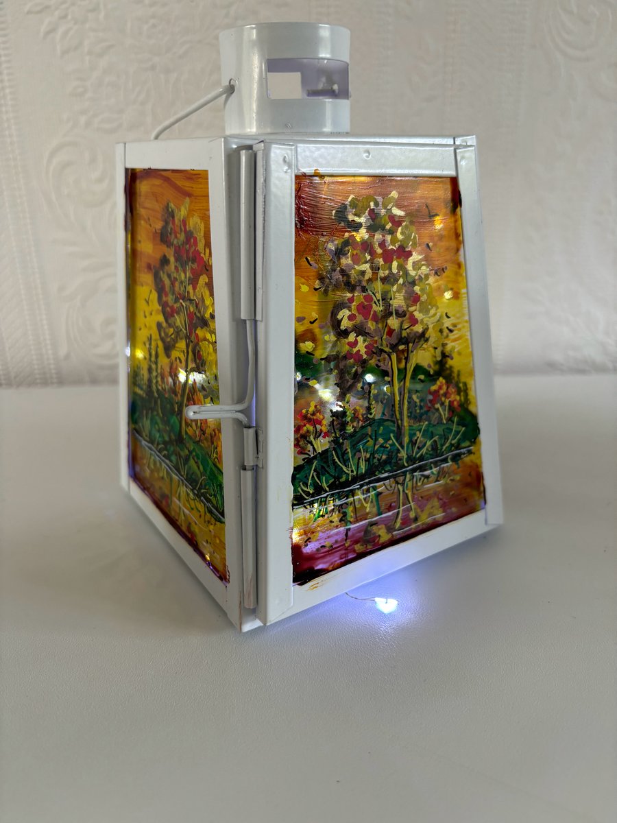 A hand painted and fired metal and glass lantern by Andrew Jenkins 