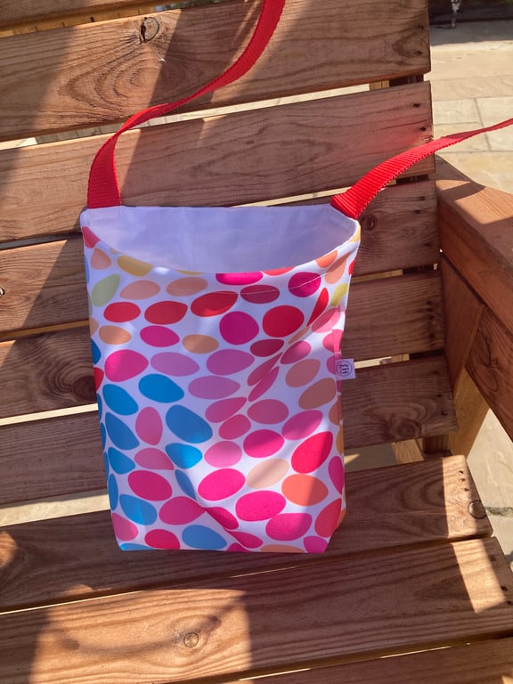 Peg bag with shoulder strap. Multi-coloured spotty showerproof fabric.