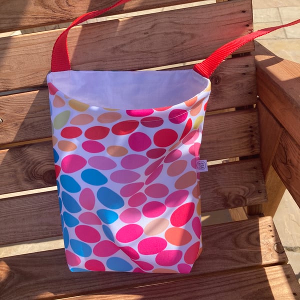 Peg bag with shoulder strap. Multi-coloured spotty showerproof fabric.