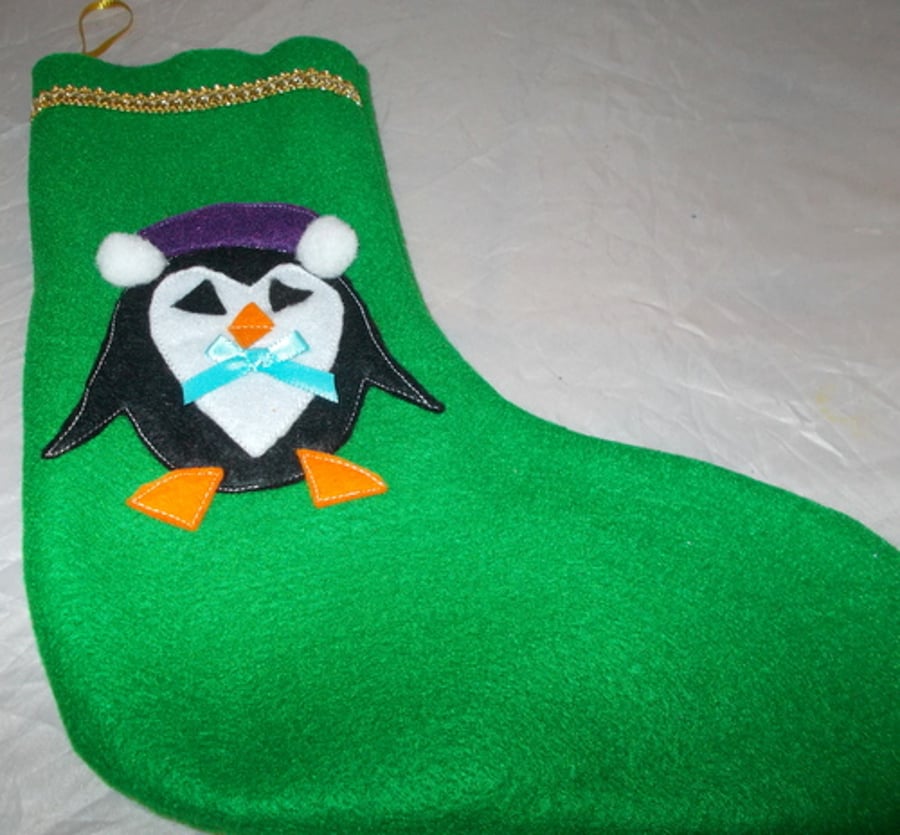 Hand made green felt Christmas stockings with appliqued pengiun